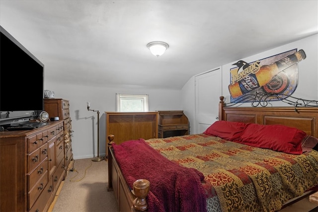 bedroom featuring light colored carpet and lofted ceiling