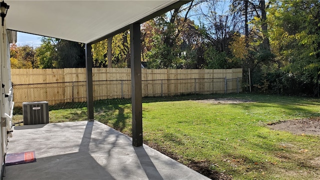 view of yard featuring central AC and a patio