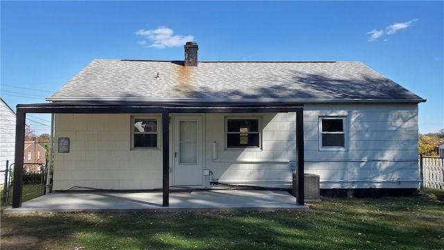 back of property with a yard, a patio area, and central air condition unit