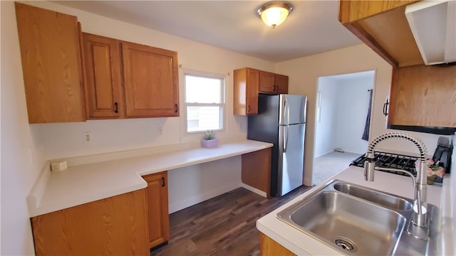 kitchen featuring stainless steel refrigerator, sink, and dark hardwood / wood-style floors