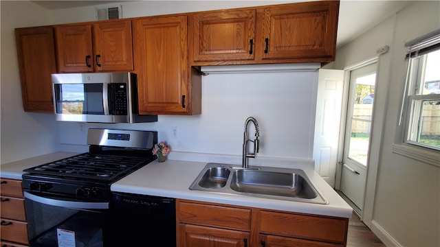 kitchen with sink and appliances with stainless steel finishes