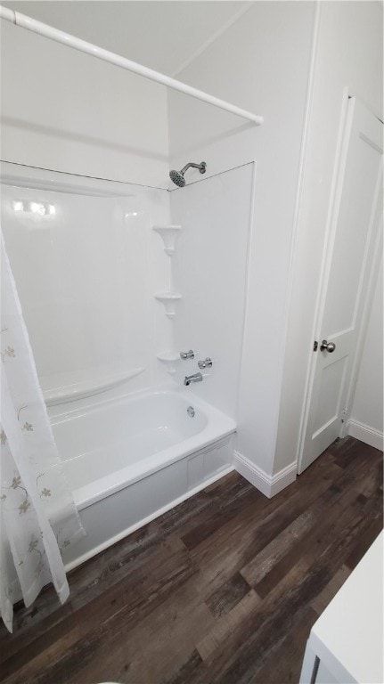 bathroom with shower / bath combo and hardwood / wood-style flooring