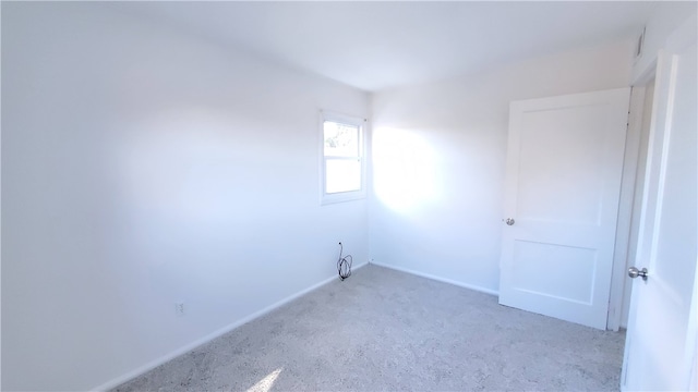 empty room featuring light carpet