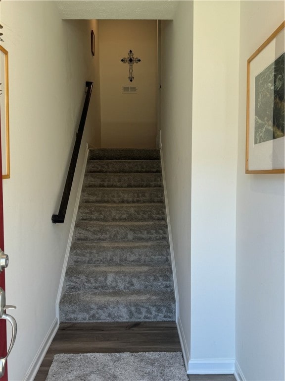 stairway with wood-type flooring