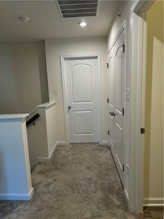 hallway with dark carpet