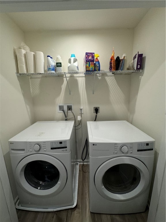 laundry area with washing machine and dryer and dark hardwood / wood-style flooring