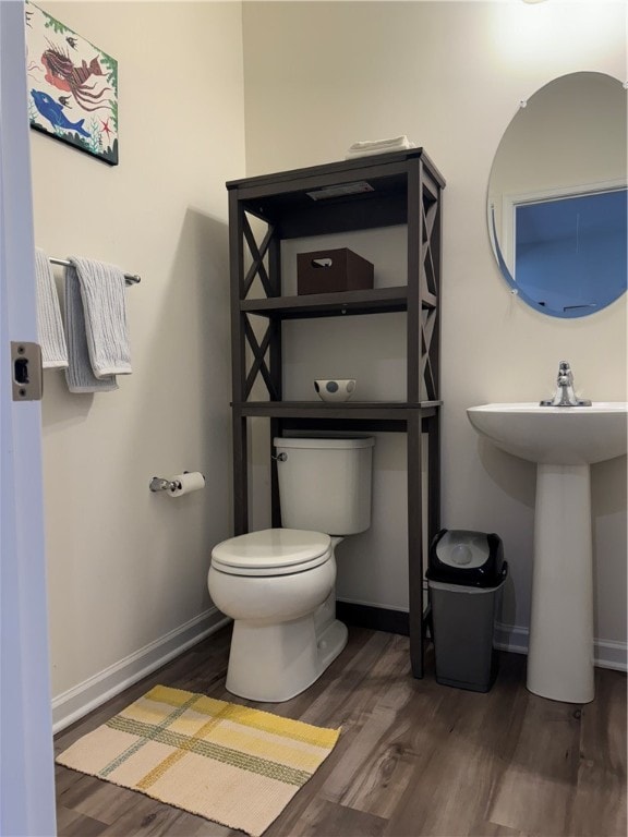 bathroom with sink, wood-type flooring, and toilet