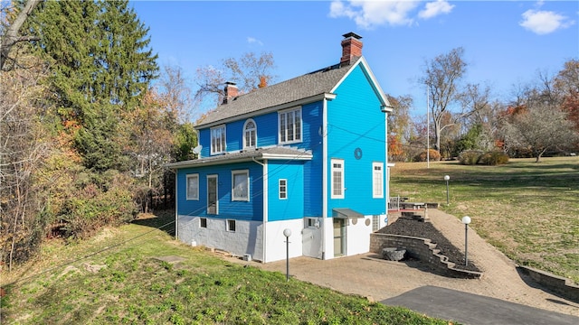 view of home's exterior with a garage and a lawn