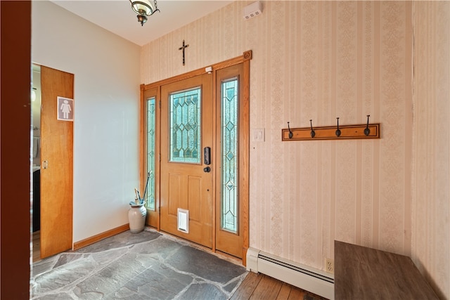 foyer entrance with dark hardwood / wood-style flooring and a baseboard heating unit