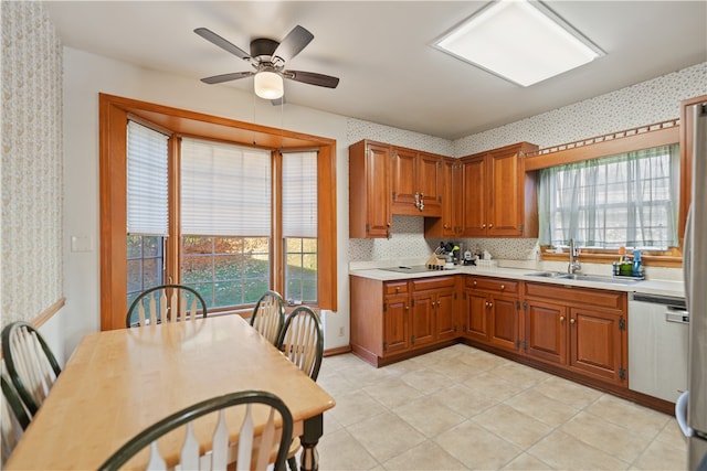 kitchen featuring decorative backsplash, ceiling fan, stainless steel dishwasher, black electric cooktop, and sink