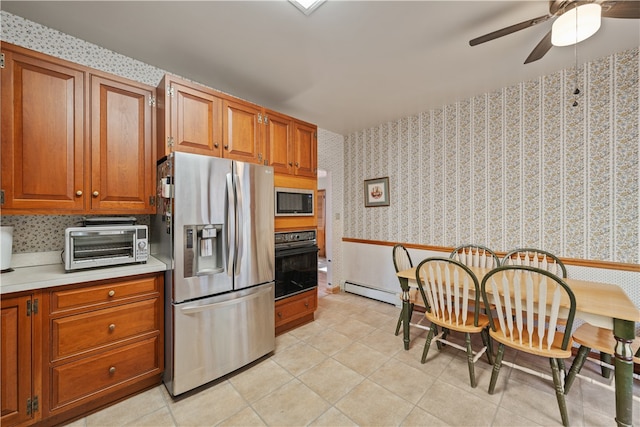 kitchen featuring ceiling fan, stainless steel appliances, and light tile patterned floors