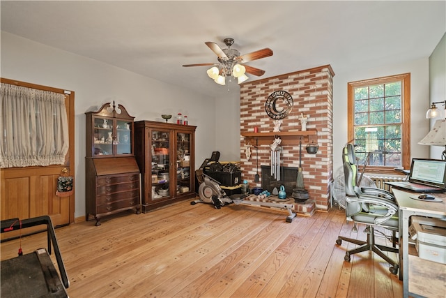 home office with ceiling fan and light hardwood / wood-style flooring