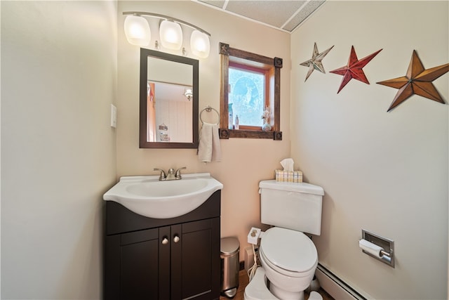 bathroom with baseboard heating, vanity, and toilet