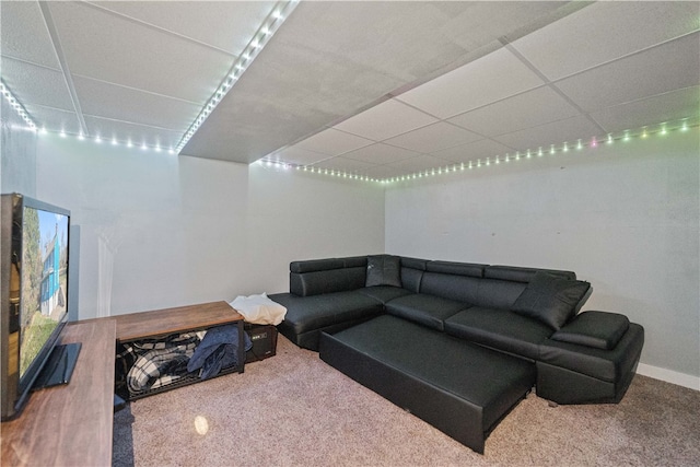 living room featuring carpet flooring and a drop ceiling