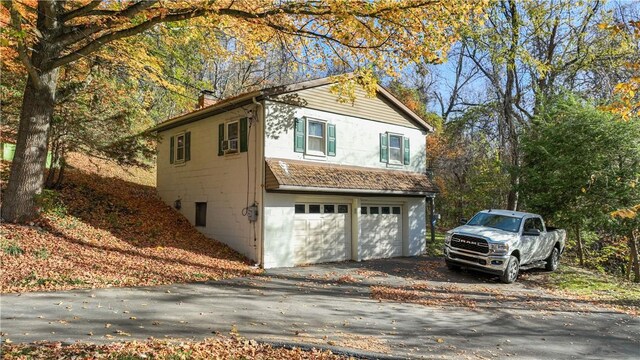 view of side of home featuring a garage