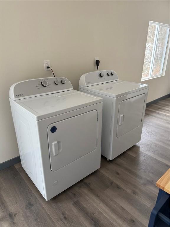 washroom with independent washer and dryer and dark hardwood / wood-style flooring