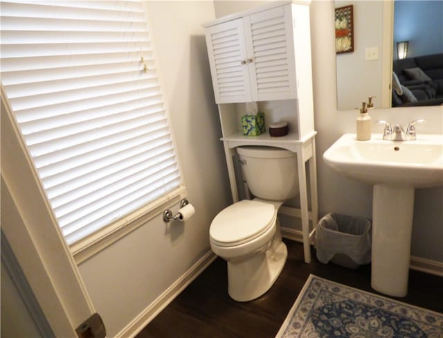 bathroom featuring sink, hardwood / wood-style floors, and toilet