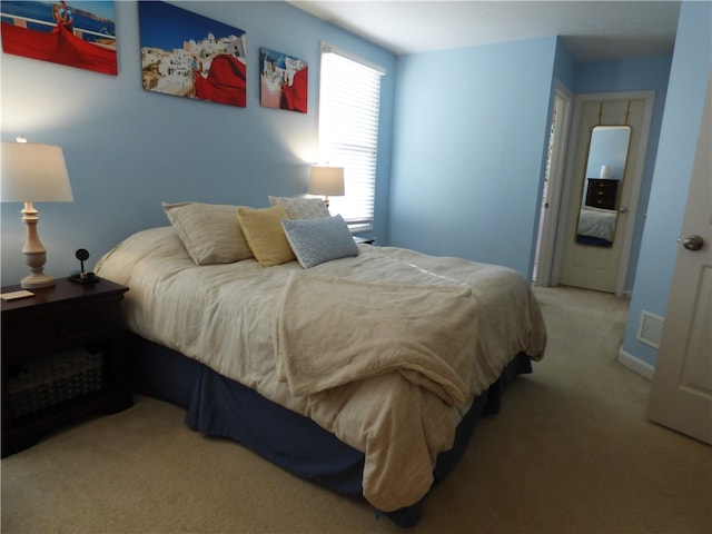 bedroom with light colored carpet