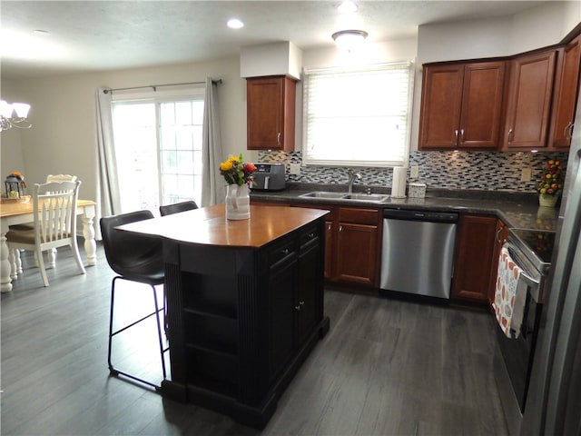 kitchen with decorative backsplash, sink, dark wood-type flooring, and appliances with stainless steel finishes