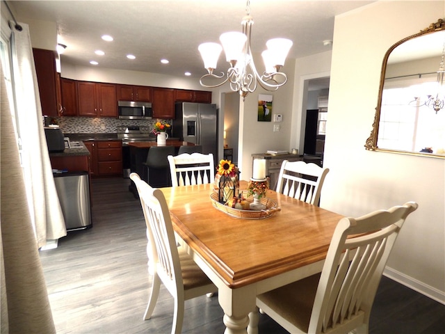 dining room featuring dark hardwood / wood-style floors and a notable chandelier