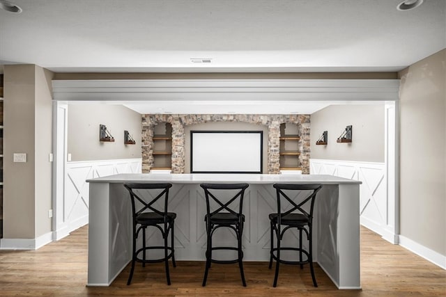 interior space featuring a kitchen bar and light wood-type flooring