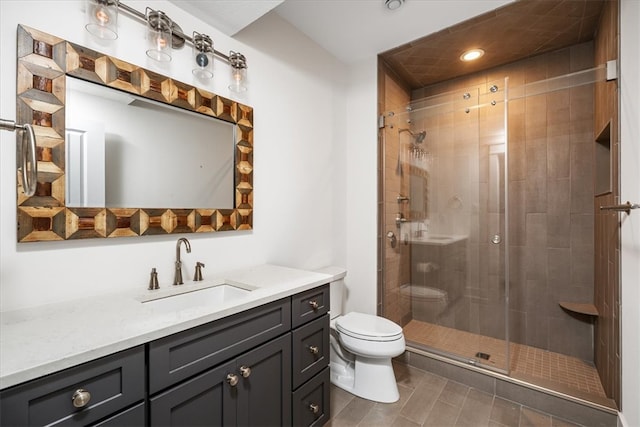 bathroom with a shower with door, vanity, and toilet