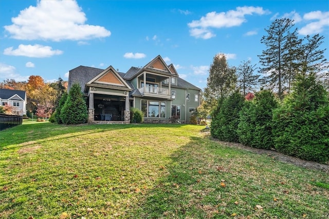 view of front of home featuring a front yard and a balcony