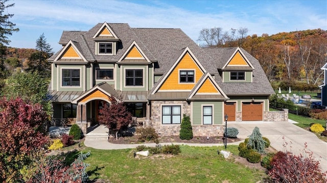 craftsman-style house with a front yard and a garage