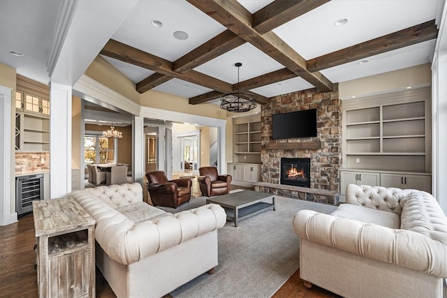 living room with beam ceiling, beverage cooler, dark wood-type flooring, a notable chandelier, and coffered ceiling