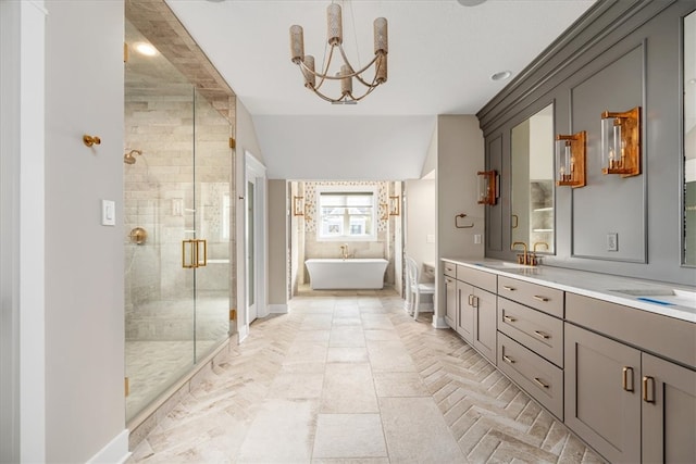 bathroom featuring vanity, an inviting chandelier, and shower with separate bathtub