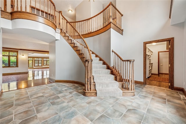 interior space with hardwood / wood-style flooring and a towering ceiling