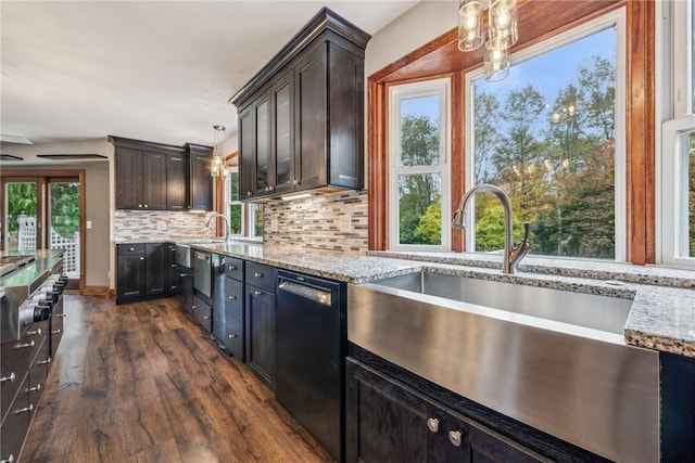 kitchen with black dishwasher, hanging light fixtures, dark hardwood / wood-style floors, and a healthy amount of sunlight