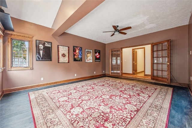 interior space with ceiling fan and dark hardwood / wood-style flooring