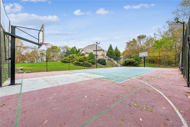 view of sport court featuring a lawn