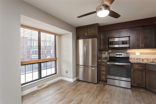 kitchen featuring appliances with stainless steel finishes, light hardwood / wood-style flooring, and dark brown cabinets