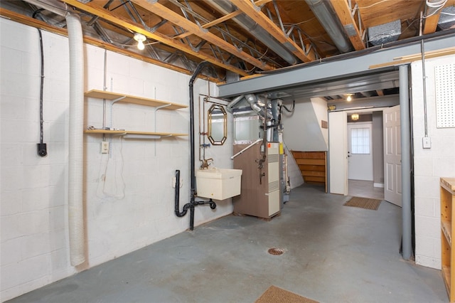 basement featuring sink and heating unit