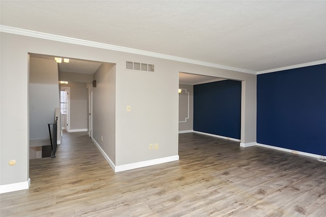 spare room with crown molding and hardwood / wood-style flooring