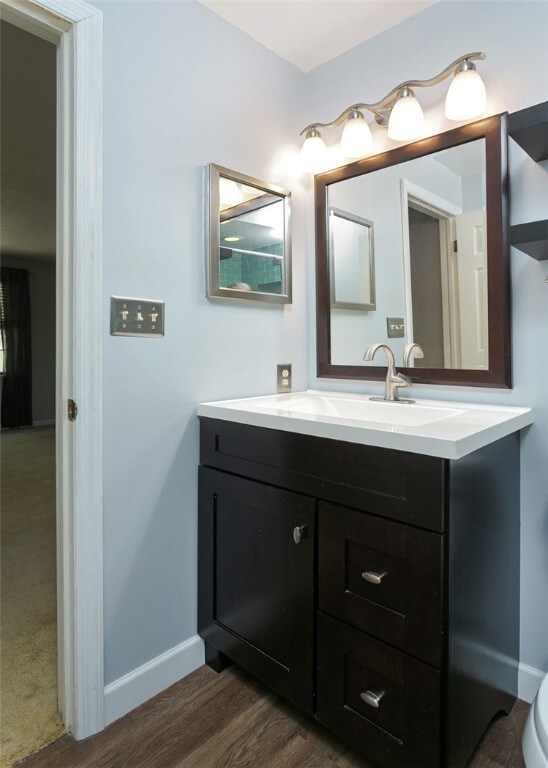 bathroom featuring vanity and hardwood / wood-style floors