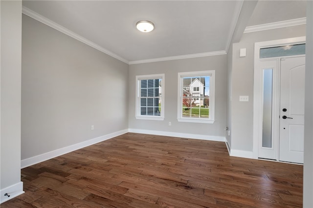 foyer entrance with ornamental molding and dark hardwood / wood-style flooring