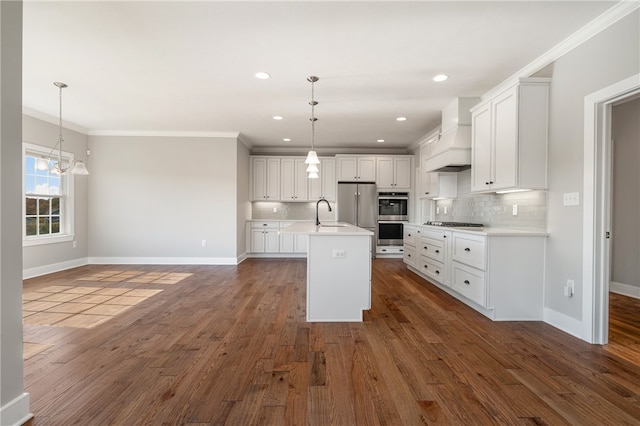 kitchen with dark wood-type flooring, stainless steel appliances, white cabinetry, and decorative light fixtures