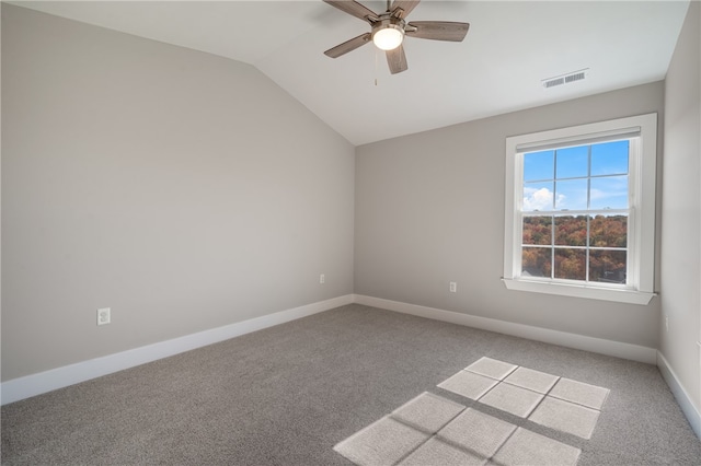 carpeted empty room featuring ceiling fan and vaulted ceiling