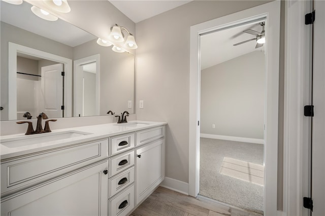 bathroom featuring vanity, ceiling fan, and wood-type flooring