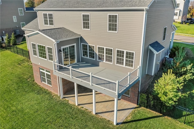 back of house featuring a wooden deck, a yard, and a patio area