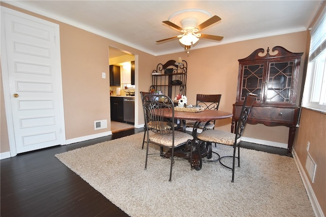 dining area with dark wood-type flooring and ceiling fan