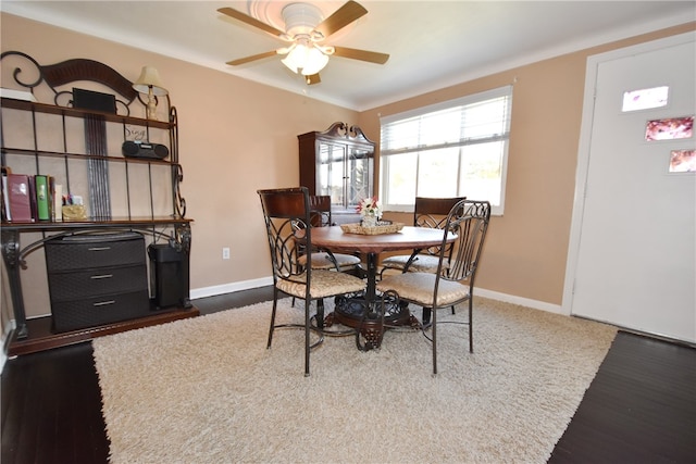 dining space featuring ceiling fan and dark hardwood / wood-style floors