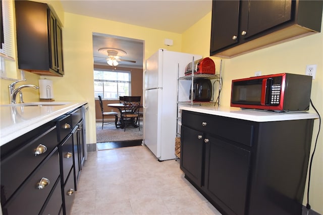 kitchen with white fridge, ceiling fan, sink, and light colored carpet