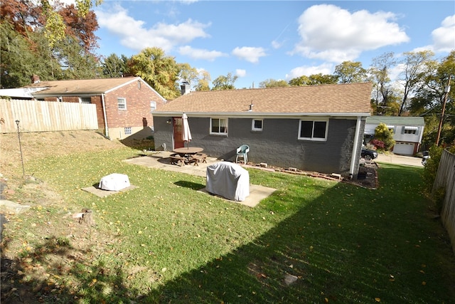 back of house featuring a patio and a lawn