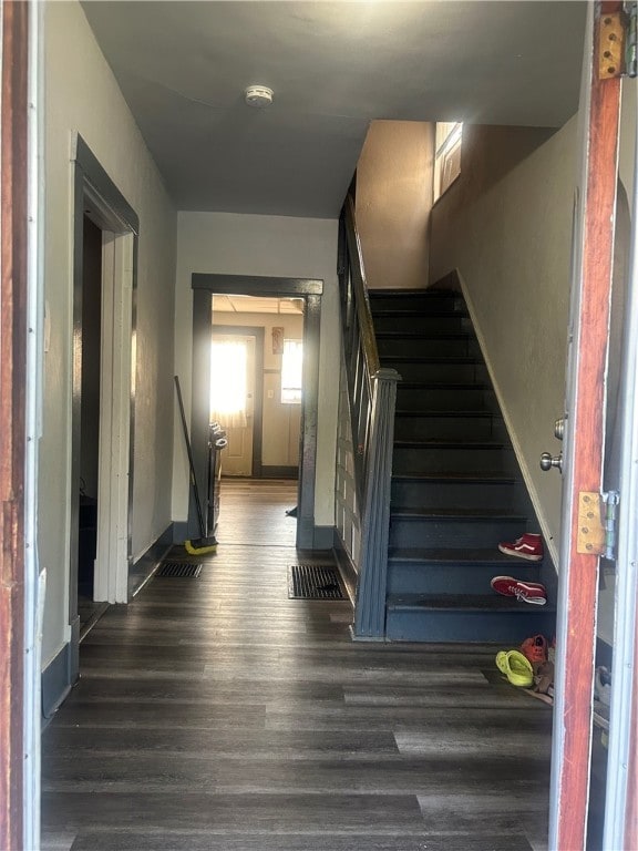 stairs featuring hardwood / wood-style flooring