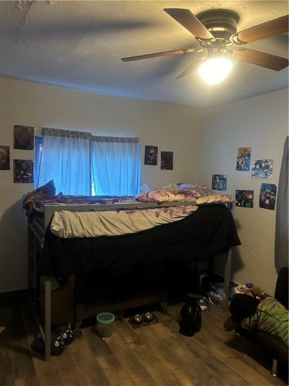 bedroom featuring hardwood / wood-style flooring and ceiling fan