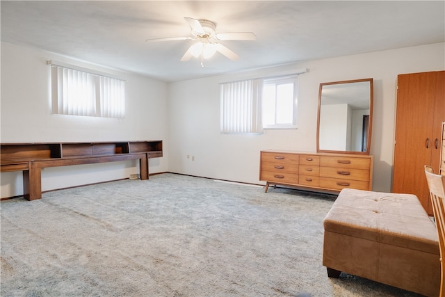 interior space with light carpet, ceiling fan, and a wealth of natural light